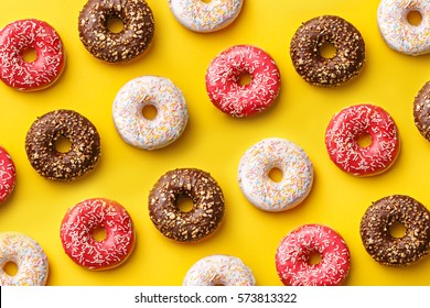 Flat lay donuts pattern on a yellow background. Top view - Powered by Shutterstock