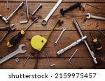 Flat lay with DYI composition of various work, carpentry tools knolled on brown wooden decks background pattern working table. Top view on new hand tool set for repair and construction kit, overhead