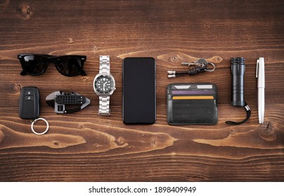 Flat lay of EDC or Every Day Carry items on wooden background