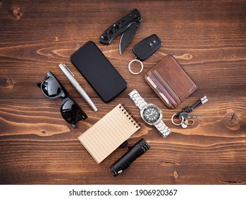 Flat lay of EDC or Every Day Carry items and tools on wooden background