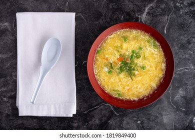 Flat Lay Of Egg Flower Soup With Soup Spoon