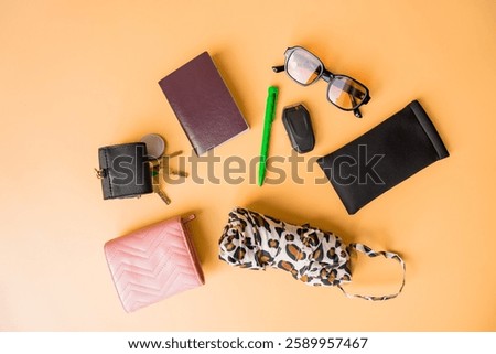 Flat lay of everyday essentials on a pastel background.