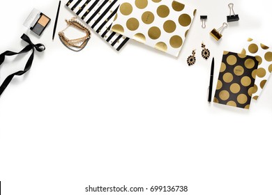 Flat Lay Fashion Feminine Home Office Workspace With Phone, Cup Of Coffee, Stylish Black Gold Notebooks, Cosmetics And Jewelry On White Background. Women's Business Desk Form Above With Space For Text