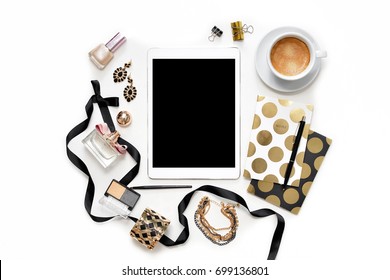 Flat Lay Fashion Feminine Home Office Workspace With Tablet, Cup Coffee, Stylish Black Gold Notebooks, Cosmetics And Jewelry On White Background. Women's Business Desk Form Above With Space For Text