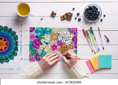Flat lay, female coloring adult coloring books, new stress relieving trend