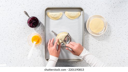 Flat Lay. Filling Empanada Dough With Blueberry Pie Filling To Make Sweet Empanadas With Blueberries.