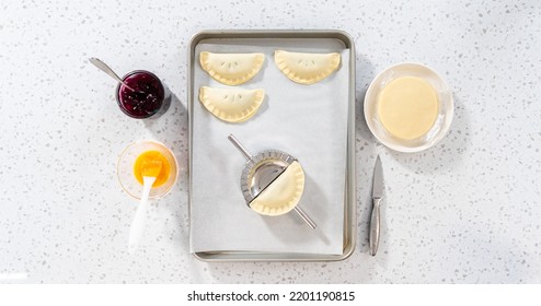 Flat Lay. Filling Empanada Dough With Blueberry Pie Filling To Make Sweet Empanadas With Blueberries.