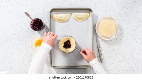 Flat Lay. Filling Empanada Dough With Blueberry Pie Filling To Make Sweet Empanadas With Blueberries.