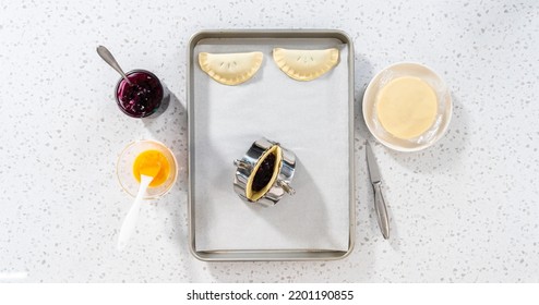 Flat Lay. Filling Empanada Dough With Blueberry Pie Filling To Make Sweet Empanadas With Blueberries.