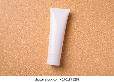 Flat lay flatlay top above overhead view photo of blank empty white tube for cream isolated over background with water drops