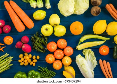 Flat lay of fresh  fruits and vegetables for background, Different fruits and vegetables for eating healthy, Colorful fruits and vegetables on blue plank background