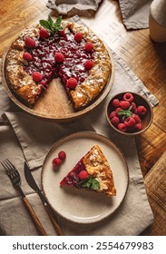 Flat lay of freshly baked raspberry galette with almond flakes