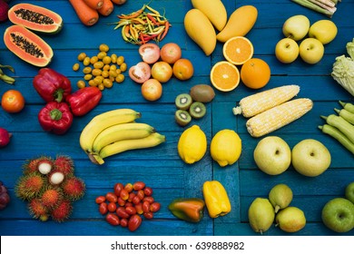 Flat lay fruits and vegetables for background, Different fruits and vegetables for eating healthy, Colorful fruits and vegetables on blue plank background
