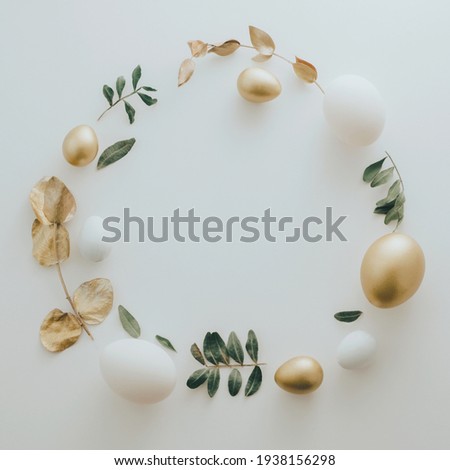 Flat Lay of Golden Easter Eggs ring circle on white background. Easter background or easter concept. Still life, pastel toned