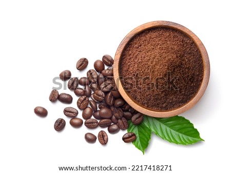 Flat lay of ground coffee with coffee beans and real coffee leaves isolated on white background.