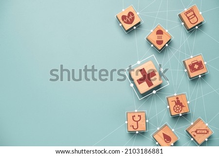 Flat lay of Health care and medical icons print screen on wooden block with connection linkage for healthy wellness insurance and assurance concept.