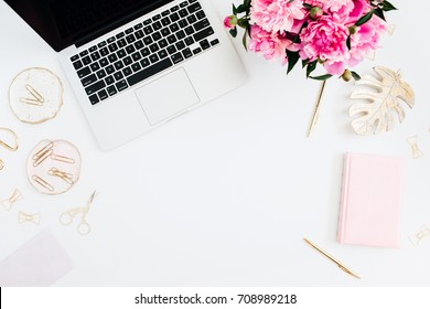 Flat lay home office desk. Female workspace with laptop, pink peonies bouquet, golden accessories, pink diary on white background. Top view feminine background. Fashion blog hero. - Shutterstock ID 708989218
