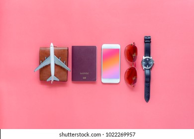 Flat lay image of accessory clothing man or women to plan travel in holiday background concept.Mobile phone & passport with many item in vacation season.Table top view several object on pink paper.