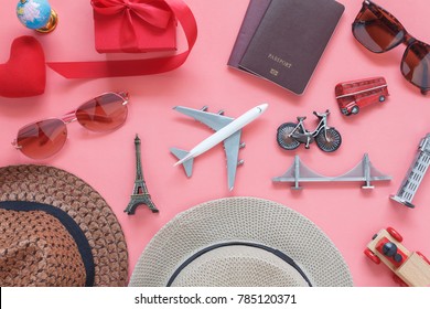 Flat lay image of accessory clothing women to plan travel in valentine's day background concept.Passport & clothes with many essential  items in holiday season.Several objects on  modern pink paper.