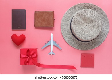 Flat lay image of accessory clothing man or women to plan travel in valentines day background concept.Passport & clothes with many items in holiday season.Table top view several object on pink paper.