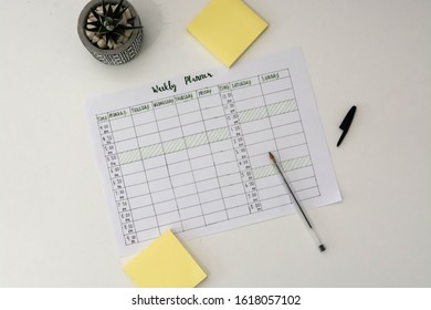 Flat Lay Image Of Weekly Planner With Stationary Scattered Around. Revision Timetable For Exams Or Activity Planner.