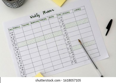 Flat Lay Image Of Weekly Planner With Stationary Scattered Around. Revision Timetable For Exams Or Activity Planner.