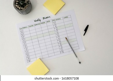 Flat Lay Image Of Weekly Planner With Stationary Scattered Around. Revision Timetable For Exams Or Activity Planner.