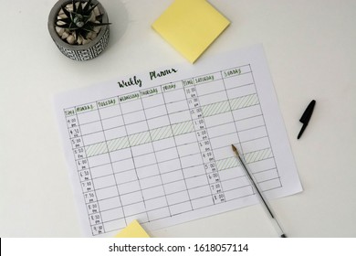 Flat Lay Image Of Weekly Planner With Stationary Scattered Around. Revision Timetable For Exams Or Activity Planner.