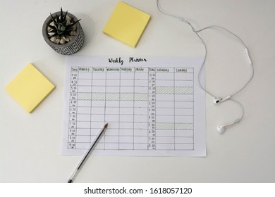 Flat Lay Image Of Weekly Planner With Stationary Scattered Around. Revision Timetable For Exams Or Activity Planner.