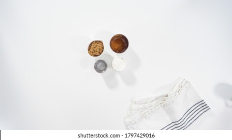 Flat Lay. Ingredients On A White Kitchen Counter To Bake Cinnamon Rolls.