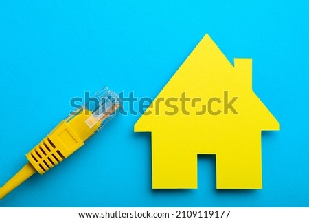 Flat lay internet cable and paper house model
