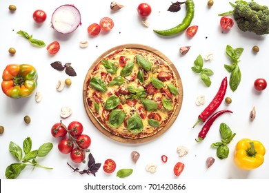 flat lay with italian pizza on wooden board and various ingredients isolated on white
