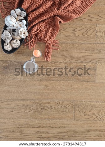 Flat Lay Of Knitted Throw And Coffee Mug Resting On Wooden Floor
