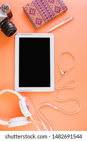 Flat Lay Of Laptop, Cell Phone, Earphones, Digital Gadget, Modern Concept On Coral Background With Copy Space