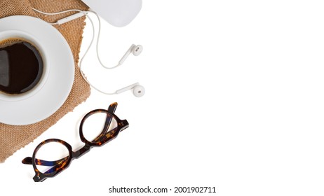 Flat lay laptop computer with camera are on top of white office desk table with eye glasses, mouse and supplies. Top view with copy space, clipping path.
