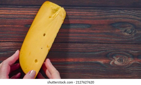 Flat Lay. Large Wedge Of Smoked Gouda Cheese On A Rustic Wood Background.