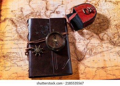 Flat Lay Leather Journal And Antique Compass On Old World Map