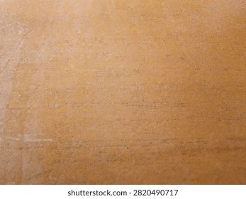 Flat Lay Macro Background Texture of Pressed Fiberboard Cardboard Panel with Natural Ochre Tan Surface Finish.
A high-resolution close-up macro photograph featuring the smooth surface texture of a brown MDF wooden fiberboard panel. The image displays fine horizontal grain lines, subtle natural fiber specks, and an even warm tan finish. Perfect as an abstract neutral background for graphic design projects, website banners, 3D texture mapping, packaging mockups, and interior carpentry concepts.