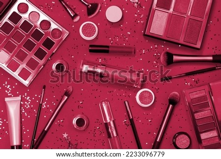 Flat lay of Makeup cosmetic product. New 2023 trending PANTONE 18-1750 Viva Magenta color