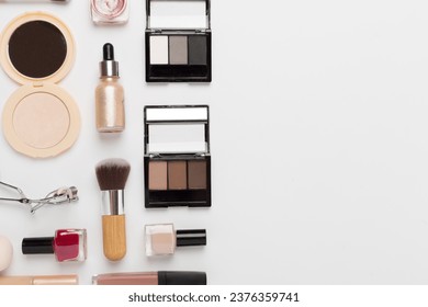 Flat lay with makeup products and tools on color background