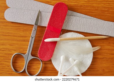 Flat Lay With Manicure Accessories, Scissors, Nail File, Cotton Pad On The Worker Table. Health And Body Care Backgrounds. Wooden Table