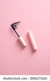Flat lay mascara with stroke on pink background.
