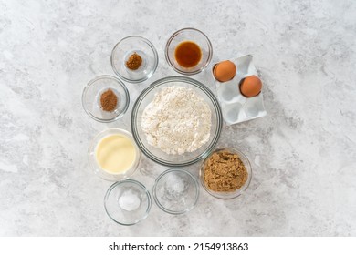 Flat lay. Measured ingredients in glass mixing bowls to bake eggnog scones.
