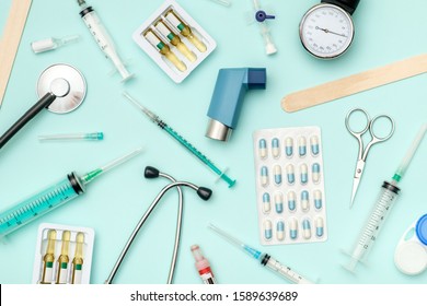 Flat Lay Of Medical Tools On Colored Background. Healthcare Insurance Concept. Table Top View Essential Doctor's Equipment