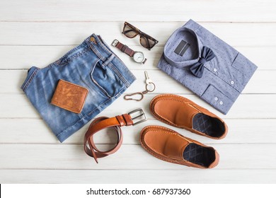 Flat lay, Men's fashion casual outfits and accessories with space on white wooden background - Shutterstock ID 687937360