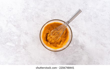 Flat lay. Mixing ingredients in a glass mixing bowl to bake sweet pumpkin bread. - Shutterstock ID 2206748441