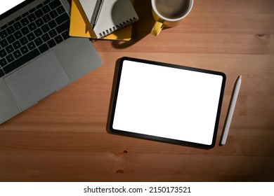 Flat lay mock up digital tablet, stylus pen and laptop computer on wooden background. - Shutterstock ID 2150173521