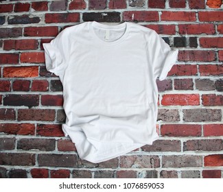 Flat Lay Mockup Of White Tee Shirt On Brick Background
