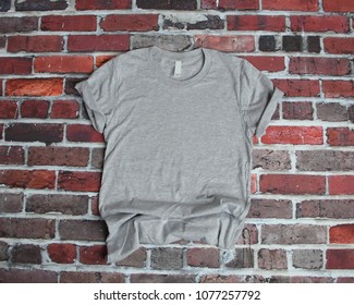 Flat Lay Mockup Of White Tee Shirt On Brick Background For Product Mockup