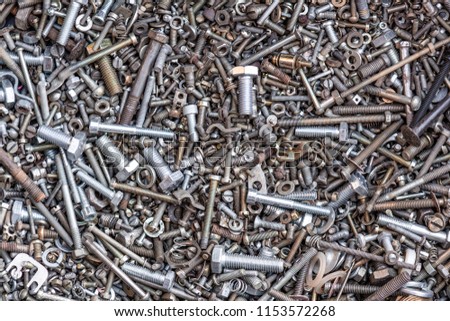 flat lay, nails and screws and nuts for work, metal small parts, many small and not new items for repair, working background, daylight
